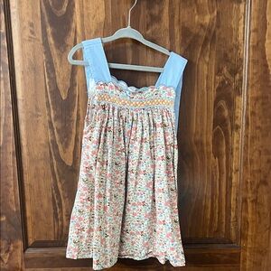Blue-Accent Floral Smocked Girls' top with matching shorts.
Bow tie sleeve